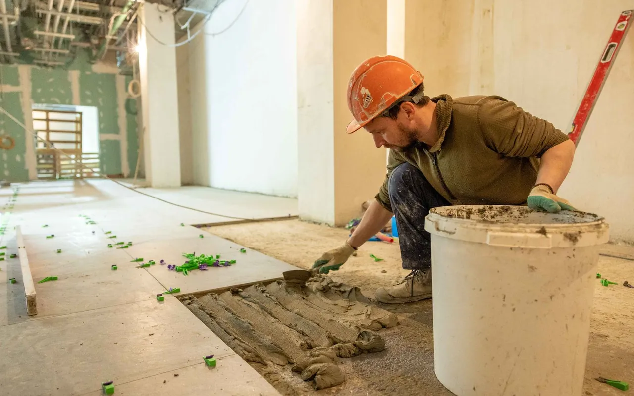 Contractor installing flooring at a home in the United States