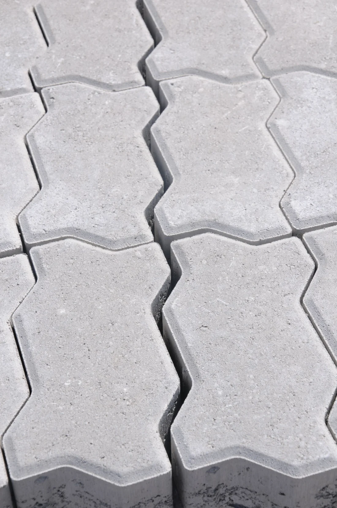 Close-up of interlocking concrete pavers with sand-filled joints