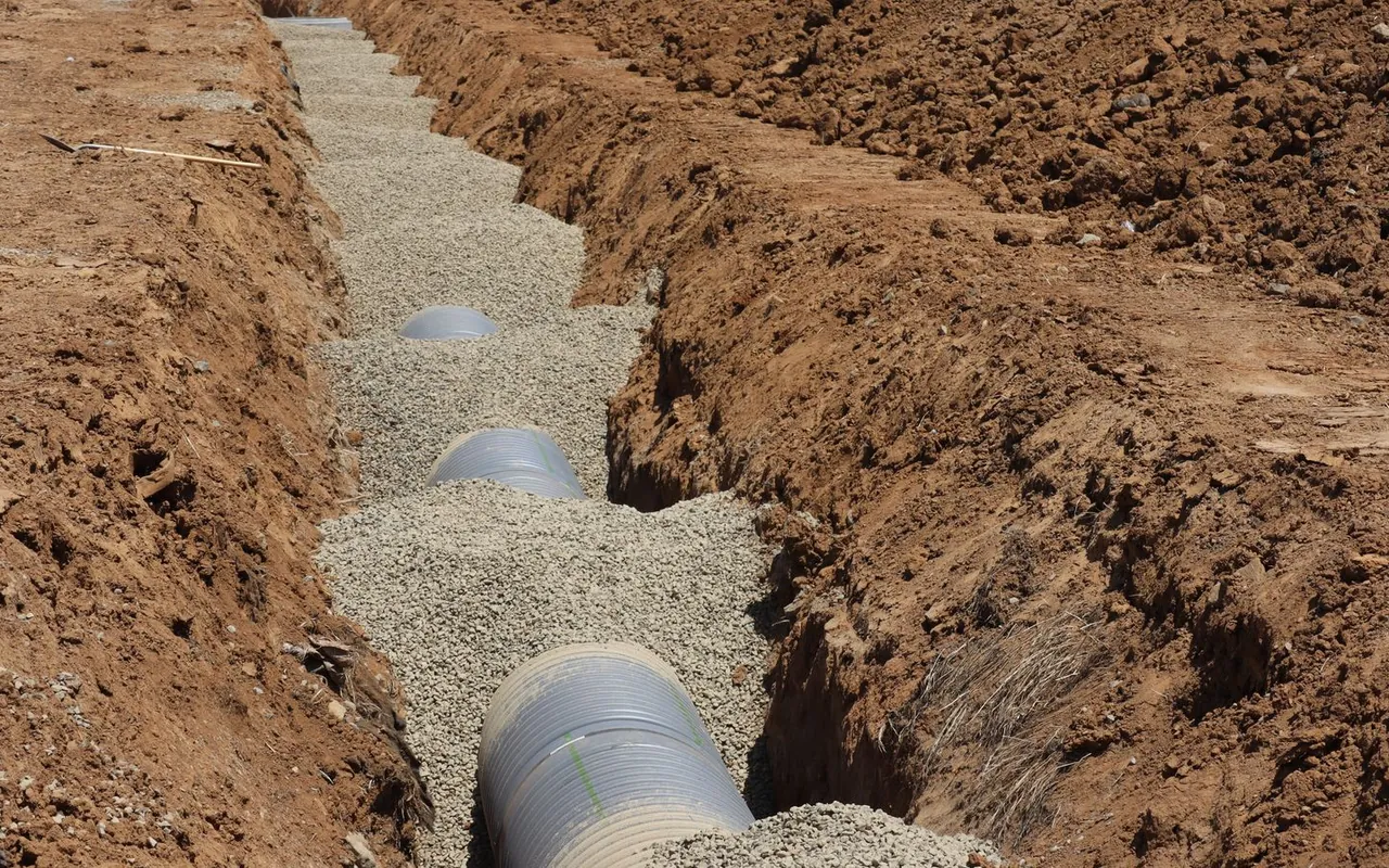 Contractor installing septic tank pumping and system at a home in the United States