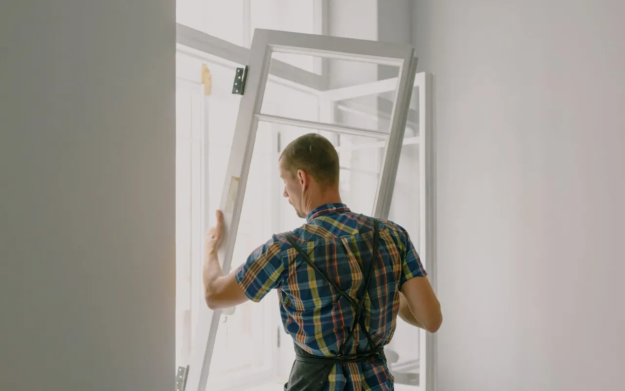 Contractor installing windows: replacement at a home in the United States